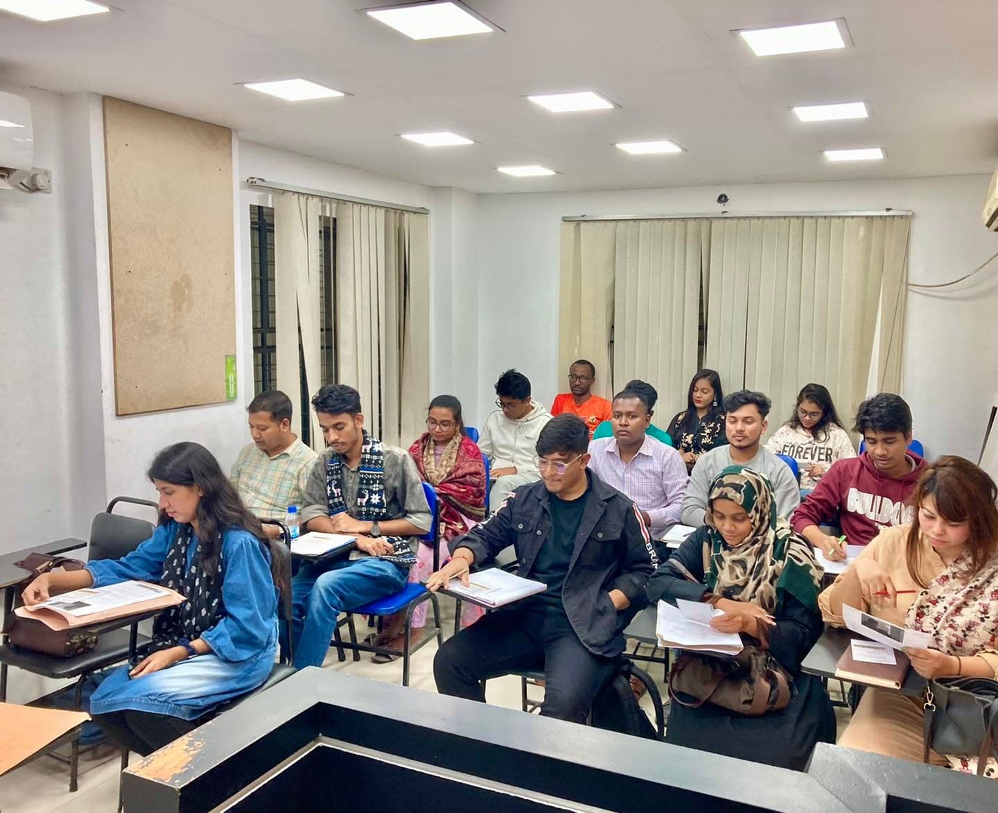 Students working through their papers during an IELTS class.