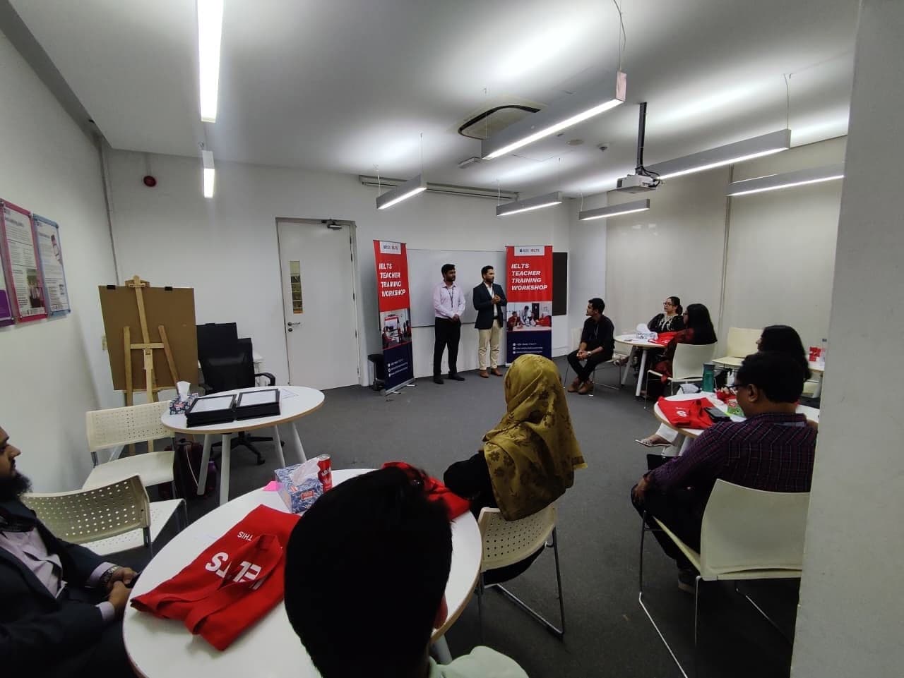 Teachers listening to a trainer at an IELTS teacher training workshop.