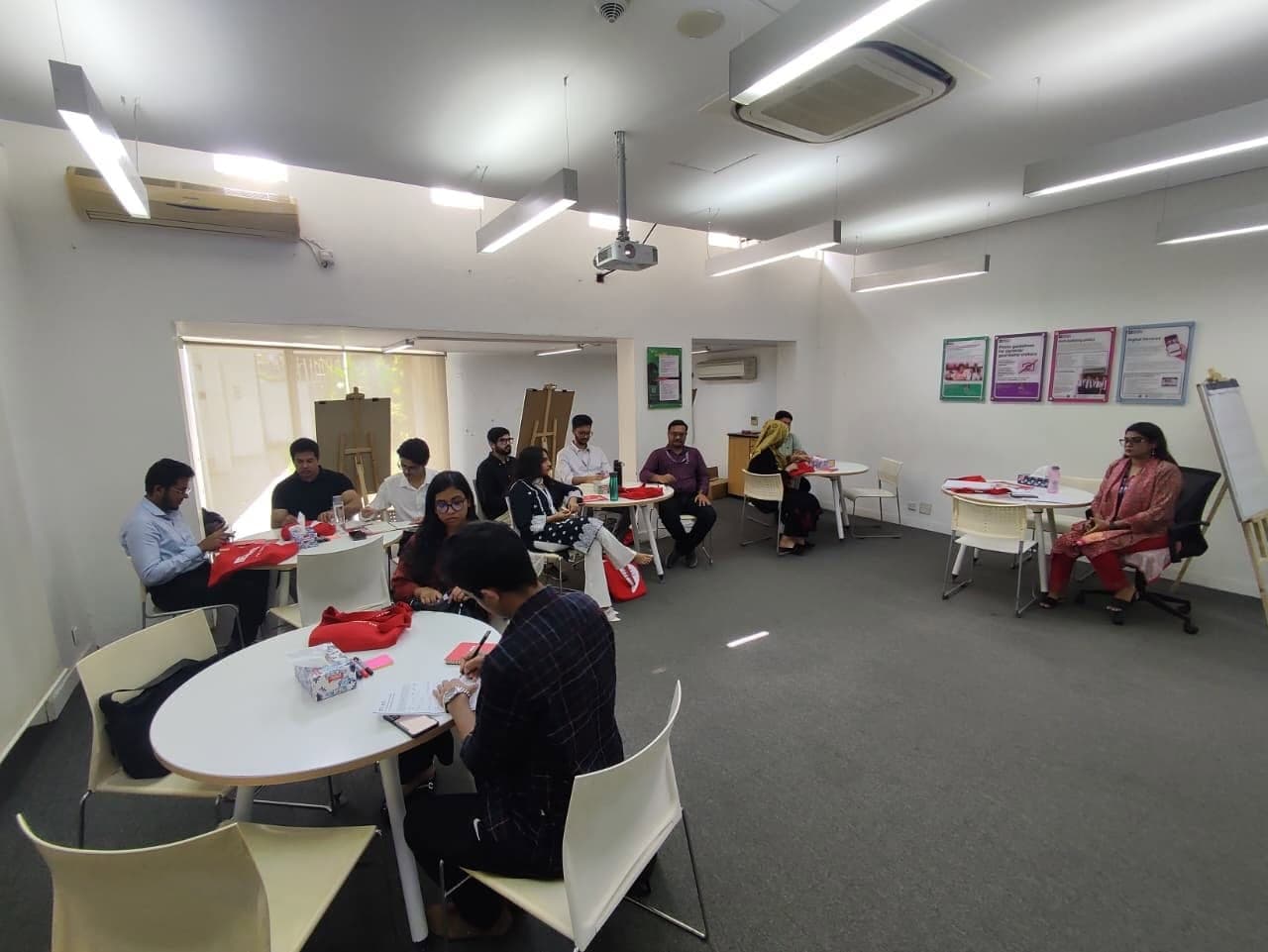 Teachers seated around tables at an IELTS teacher training workshop.